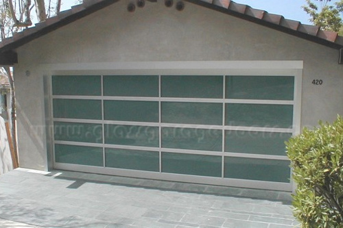 Modern full-view bp glass garage door, enhancing a contemporary home's facade in Laguna Beach CA with clean lines and a bold color accent.