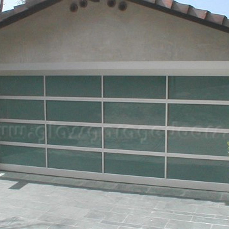 Modern full-view bp glass garage door, enhancing a contemporary home's facade in Laguna Beach CA with clean lines and a bold color accent.