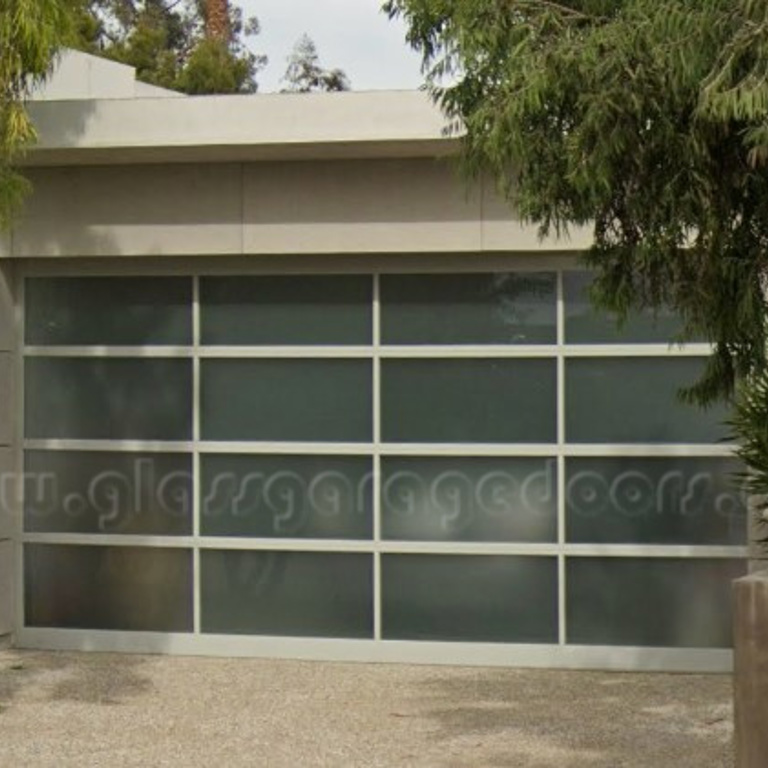 bp Glass Garage Door in garage of coastal home in Corona del Mar, California with powder coated aluminum frame