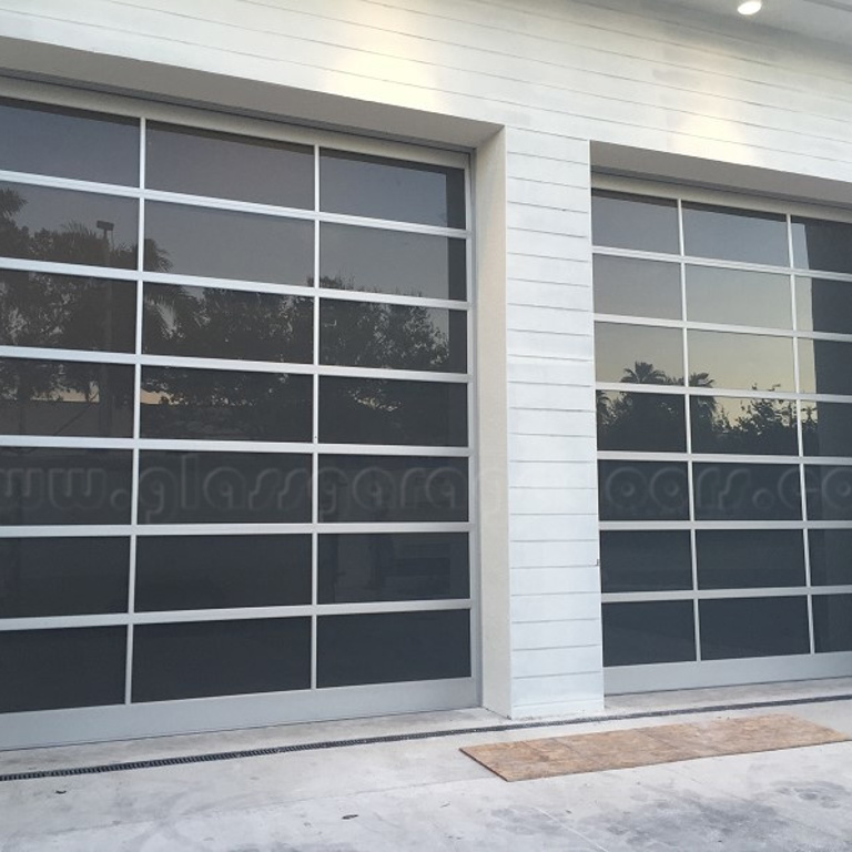 A pair of clear anodized bp Glass Garage Doors in Doral Florida