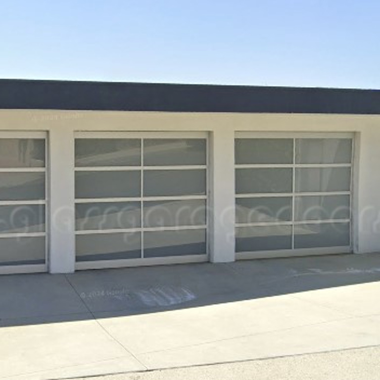 Three modern full-view glass garage doors, offering a contemporary and private façade to a residential garage.
