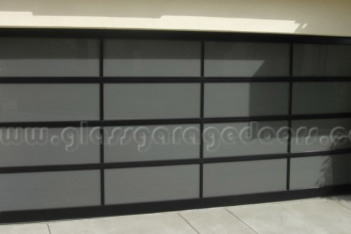 Full-view bp glass garage door with dark tinted panels and sleek black frames, providing privacy and a sophisticated modern aesthetic for residential properties 