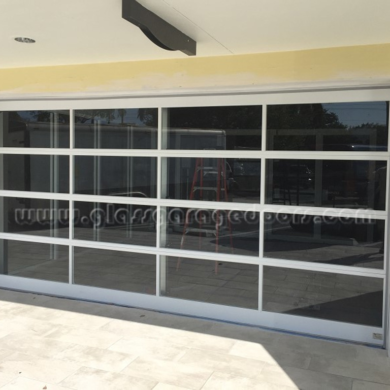 Impact rated with clear glass bp Glass Garage Door in Coral Gables, FL
