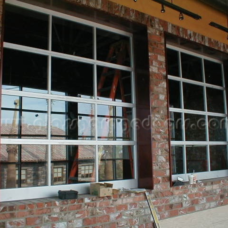 bp Glass Garage Doors as window shutters, integrated to a commercial building for a contemporary look.