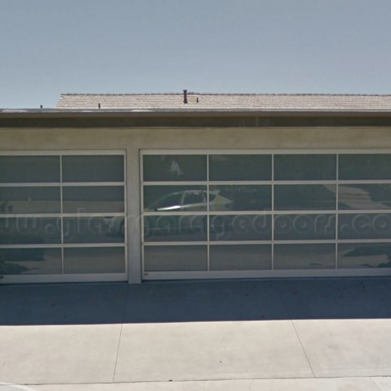 Single and Double bp Glass Garage Doors in Corona del Mar home featuring modern coastal design and aluminum frame