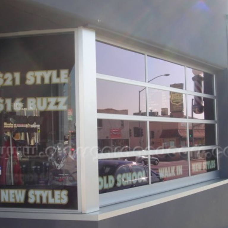 Modern commercial bp glass storefront, serving as an expansive window display for a barbershop.