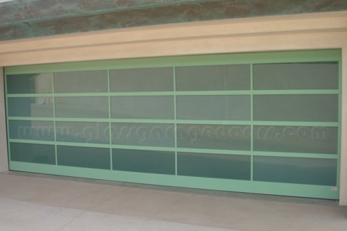 Aluminum-framed bp glass garage door with a unique light green kynar painting finish, creating a cohesive and contemporary look on a residential property.